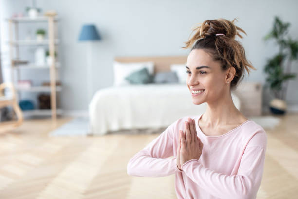 Namaste gesture close up, young smiling woman practicing yoga, working out. Concept lifestyle.